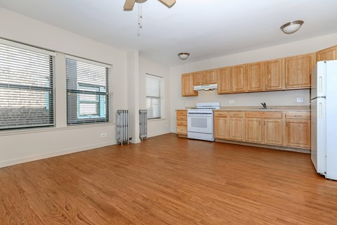 A kitchen with wooden cabinets and a white refrigerator.
