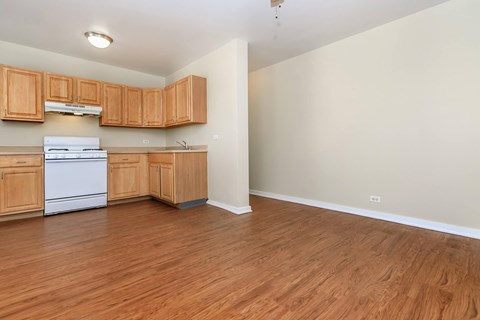 A kitchen with wooden cabinets and a white dishwasher.
