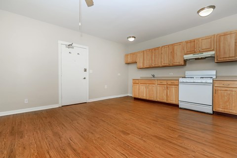 A kitchen with wooden cabinets and a white dishwasher.