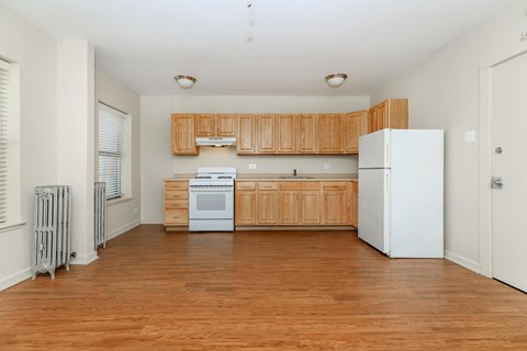 A kitchen with wooden cabinets and white appliances.