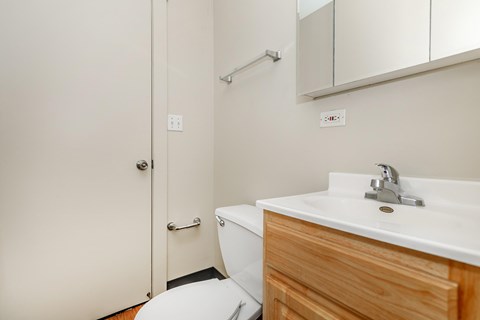 A white sink with a wooden drawer underneath it.