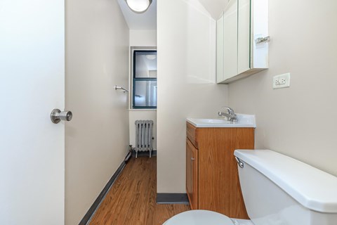 A white bathroom with a toilet, sink, and bathtub.