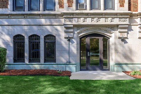 A building with a white facade and a large arched entrance.