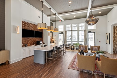 A modern kitchen with a dining area and a living room.