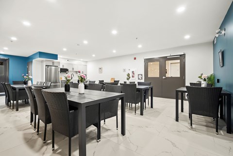 A modern dining room with a large table and chairs.