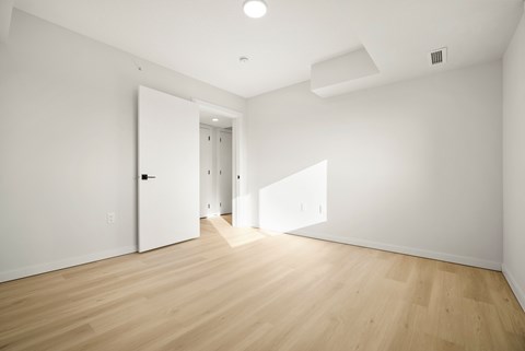 A room with wooden floors and white walls.