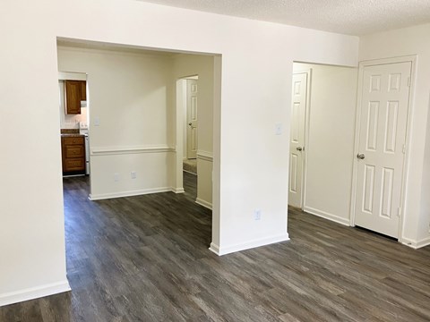 A room with white walls and wood flooring.