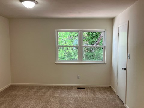 A room with a window and a door.