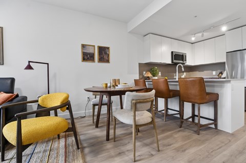 A modern kitchen with a dining table and chairs.