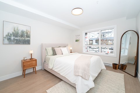 Bedroom with a Nightstand at Woodland Place Apartments, British Columbia, L4H 3P6