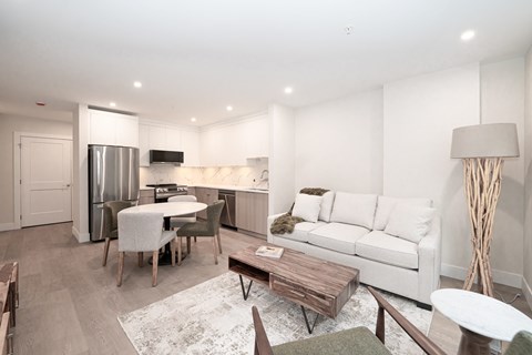 A modern living room with a white couch and a wooden coffee table.