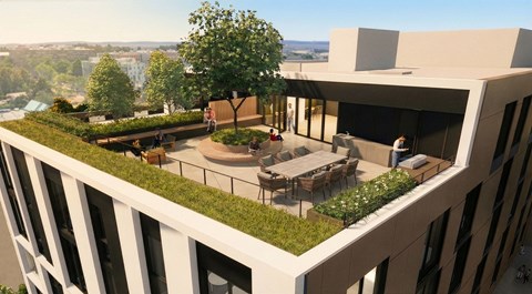 A modern building with a rooftop garden and people enjoying the outdoor seating area.at Haven, Vancouver British Columbia