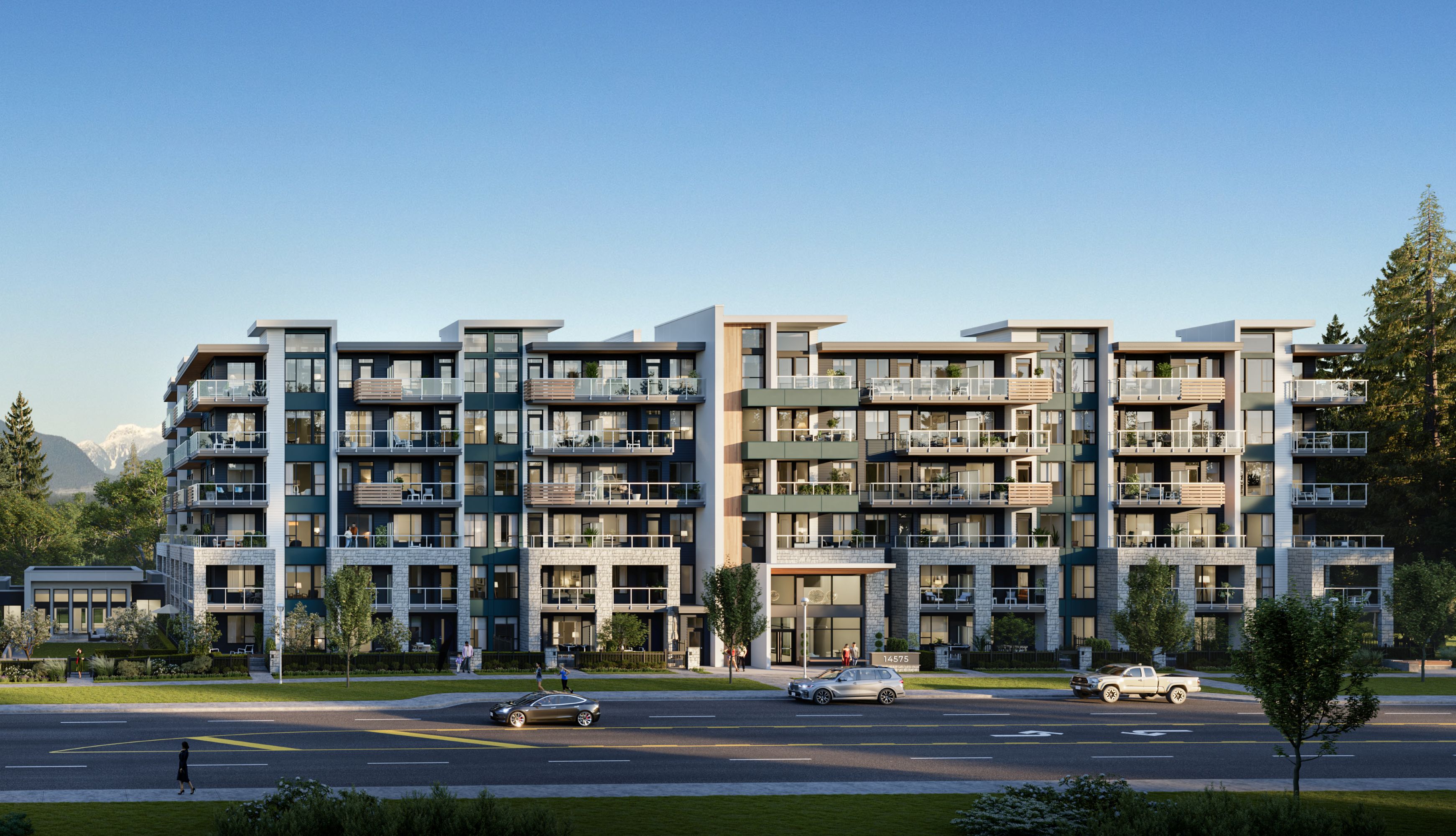 A large apartment complex with cars parked in front.