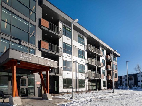 A large building with the words "Birchwood Apartments" on the front entrance.