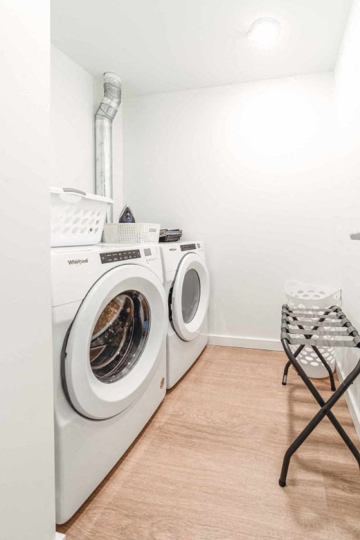 A laundry room with a washer and dryer and a folding chair.