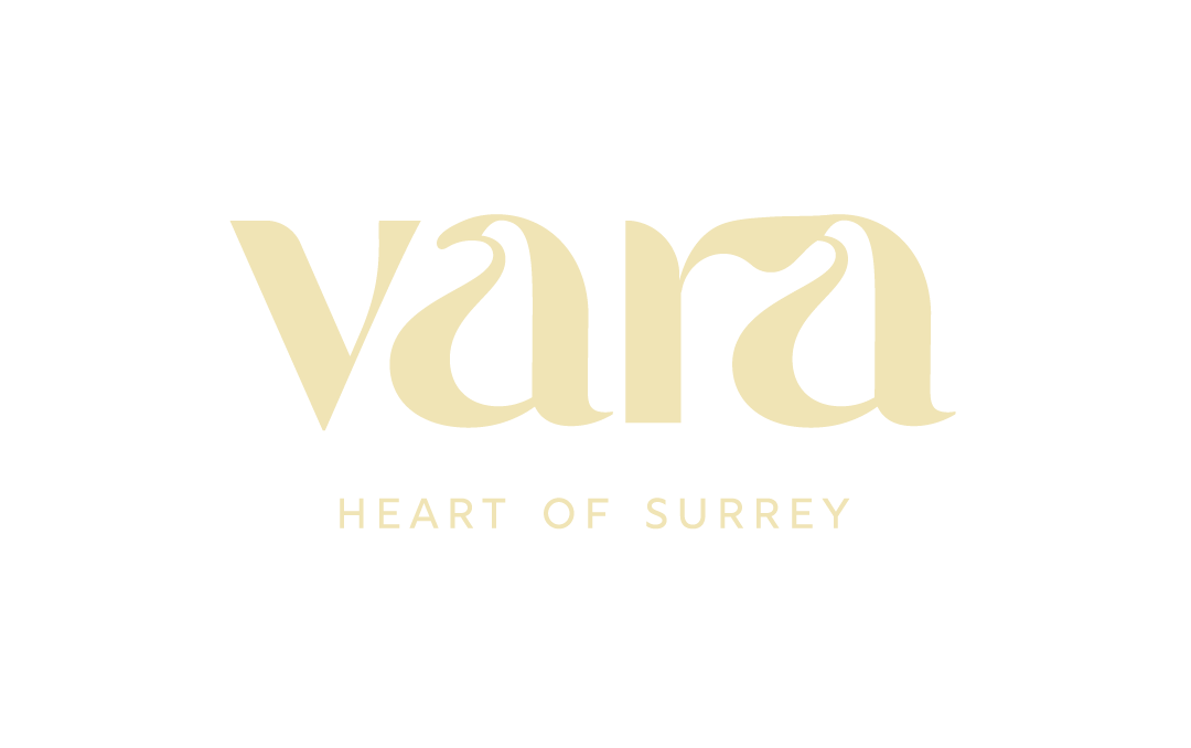 A logo with the text "vara" in a stylized font and "heart of surrey" in smaller text below it.