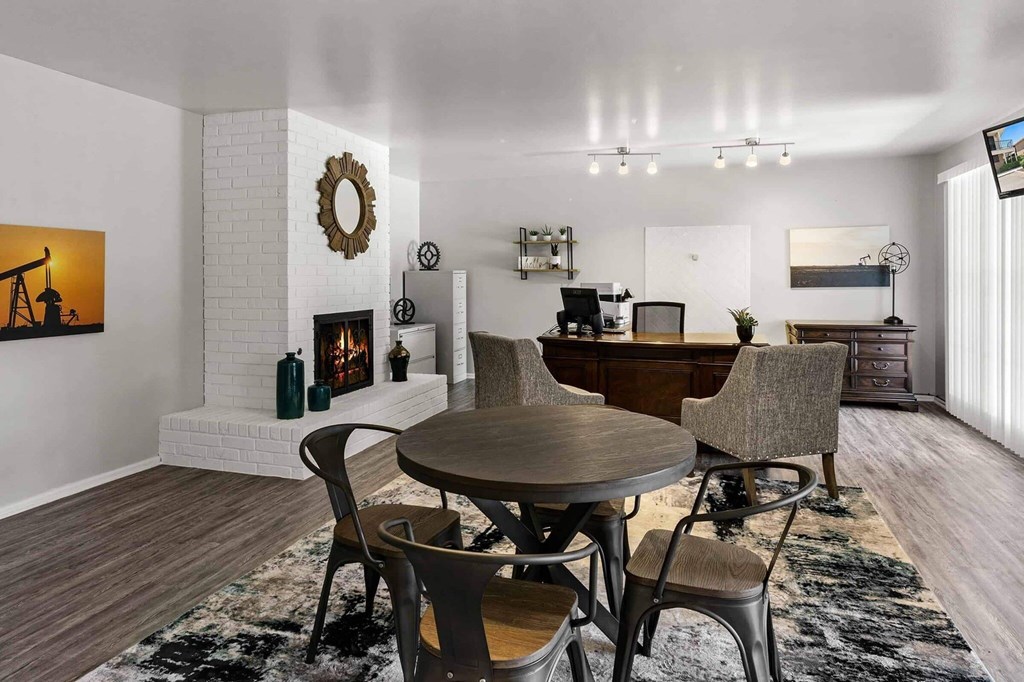 A modern dining room with a round table and chairs.