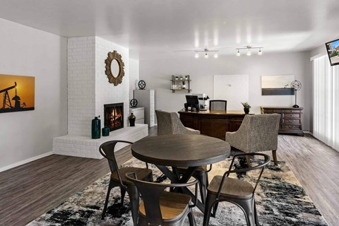 A modern dining room with a round table and chairs.