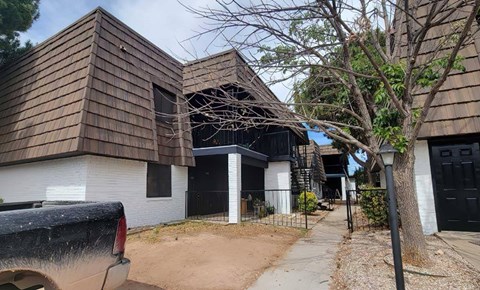 A modern house with a brown shingled roof and a white garage door.
