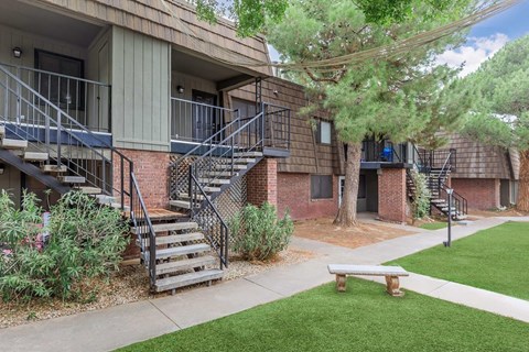 A small building with a balcony and stairs leading to the second floor.