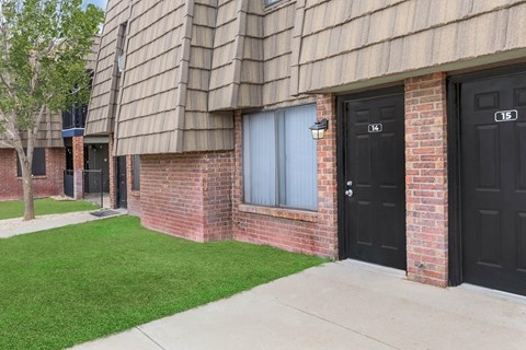A building with black doors and windows numbered 104 and 105.