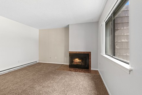A room with a fireplace and carpeted floor.