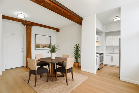 A dining room with a table and chairs.