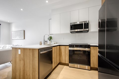 A modern kitchen with wooden cabinets and stainless steel appliances.
