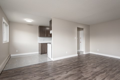 A room with wooden flooring and a cabinet in the corner.
