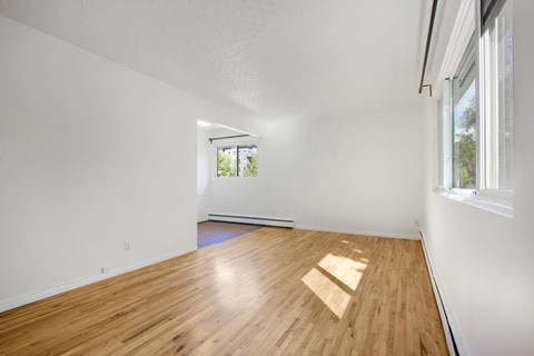A room with wooden flooring and a window.