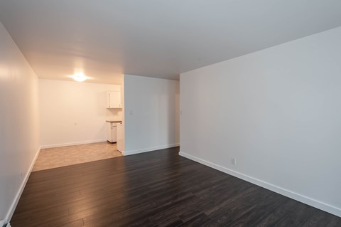 A room with a wooden floor and white walls.