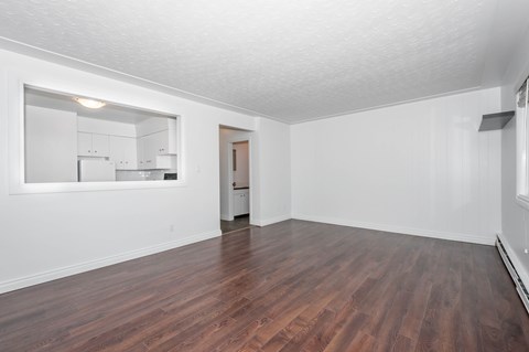 A room with wooden floors and white walls.