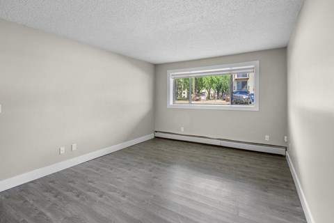 Empty room with a window showing a street view.
