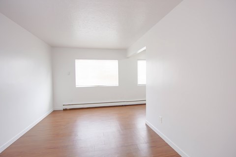 A room with wooden floors and a window.