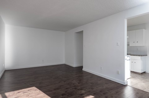 A room with wooden floors and white walls.