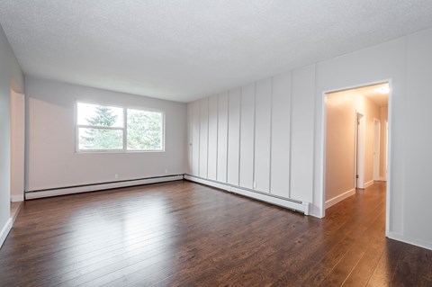 A room with wooden floors and white walls.