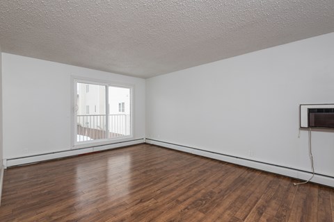 A room with wooden floors and a window.