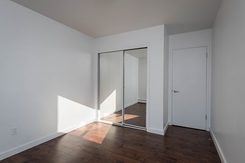 A room with a white door and a white wall.