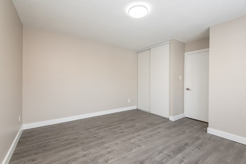 A room with a grey floor and white walls.