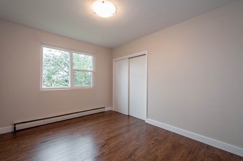 A room with a window and a closed door.
