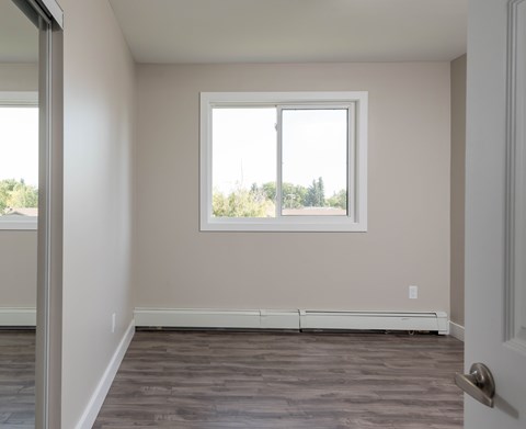 A room with a window and a door.