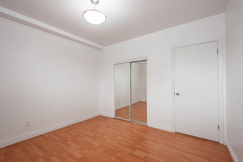 A room with a wooden floor and white walls.