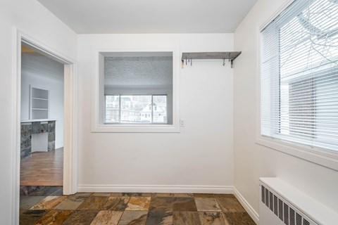 A room with a window and a radiator on the wall.