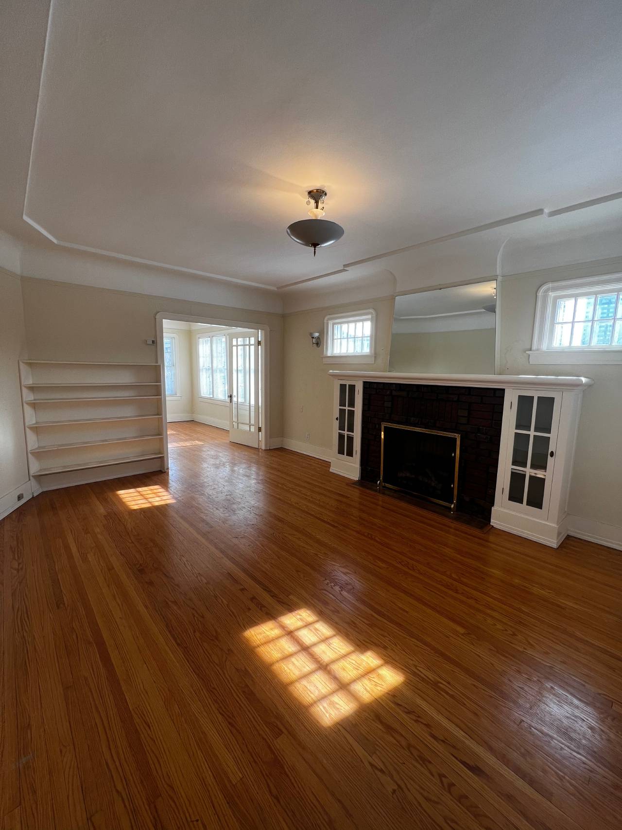 A wooden ceiling with a skylight and a white wall.