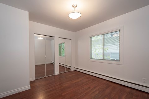 A room with a sliding glass door and a window.