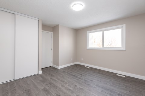 A room with a sliding door and a window.