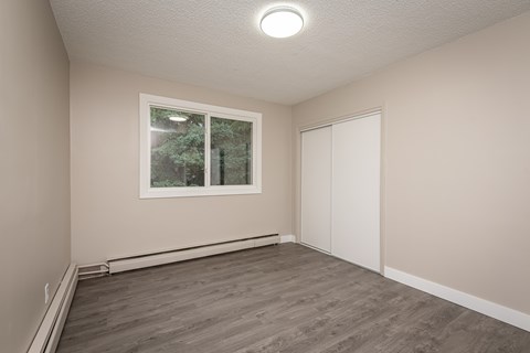 A room with a window and a closed door.