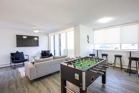 A foosball table sits in the middle of a living room.