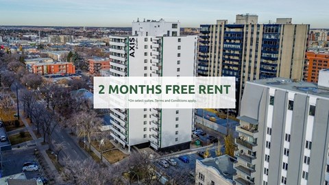 A cityscape with apartment buildings and a sign offering 2 months free rent.