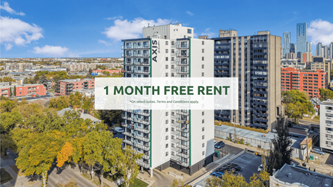 A tall building with the text "1 MONTH FREE RENT" in front of a cityscape.